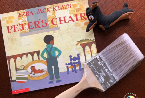 Peter’s Chair shows a little boy looking at his chair with a paintbrush and stuffed dog next to it